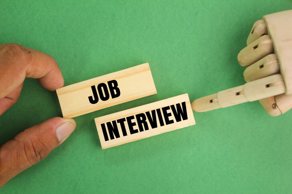 hand holding a stick with the word job interview. the concept of human resources or HR.